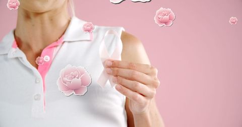 Woman Holding Breast Cancer Awareness Ribbon on Pink Background