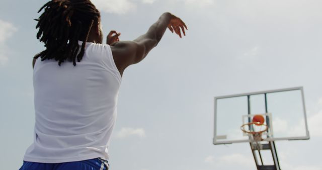 Man Shooting Basketball Outdoors with Outstretched Arm - Download Free Stock Images Pikwizard.com