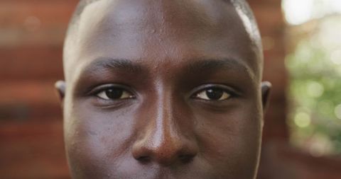 Focused Gaze of Young African American Man in Warm Toned Background