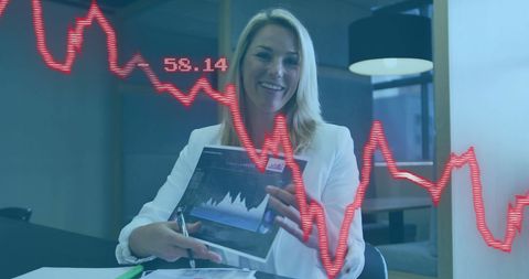 Businesswoman Analyzing Financial Charts with Technology