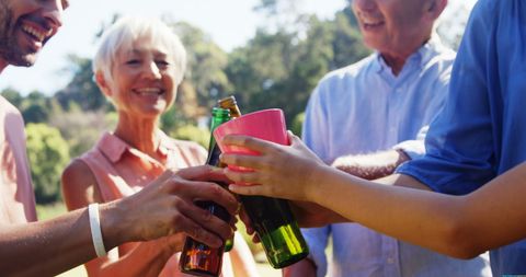 Joyful Group Celebrating Outdoors with Drinks