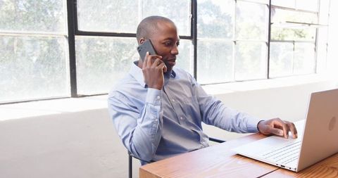 Professional Busy With Smartphone And Laptop in Modern Office
