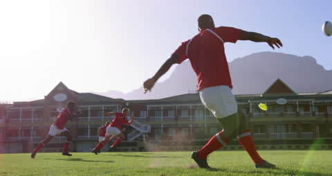 Rugby Players Performing Kick During Practice on Field