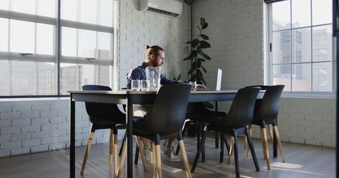 Contemplative Man Working at Modern Office Desk