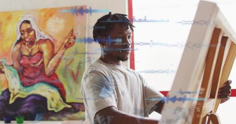 Black artist holding canvas in bright studio with colorful mural, easel and blue waveform overlay