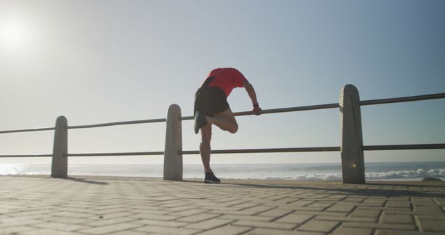 Male Athlete Stretching by Ocean at Sunrise - Download Free Stock Images Pikwizard.com