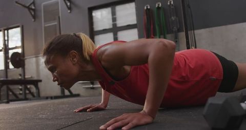 Fit African American Woman Performing Push-Ups in Gym Environment