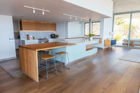 Sunlit minimalist kitchen island featuring wood counter and pale blue base