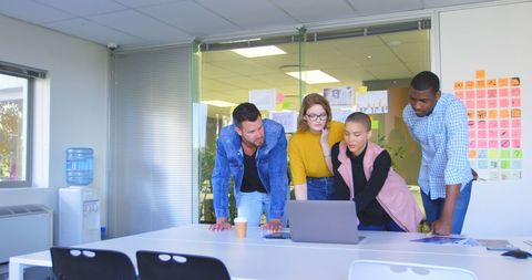 Diverse Business Team Collaborating Over Laptop in Modern Office - Download Free Stock Images Pikwizard.com