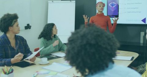 Empowered Businesswoman Leading Meeting with Creative Presentation