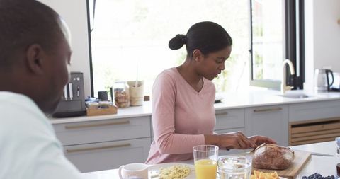 African American Couple Enjoying Breakfast in Modern Sunny Kitchen