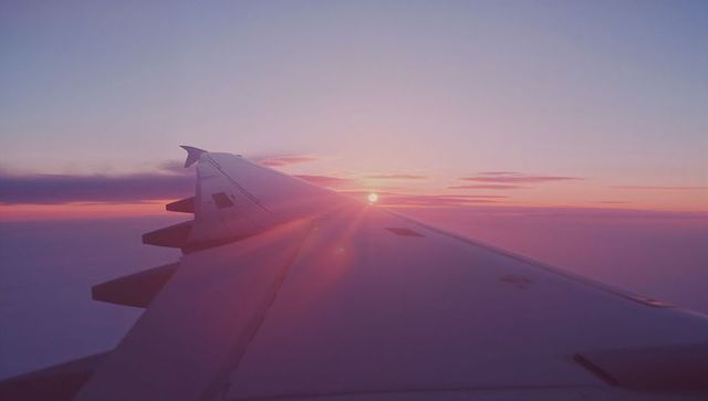 Airplane Wing and Beautiful Dawn Horizon from Window View