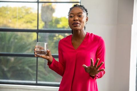 Dynamic Professional Woman Speaking in Modern Office Environment