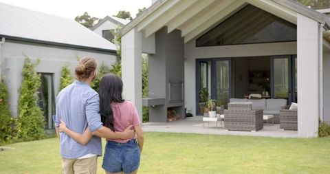 Happy Young Couple Embracing Outdoors Luxury Modern Home - Download Free Stock Images Pikwizard.com