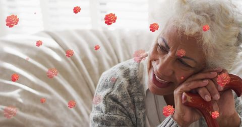 Smiling Senior Woman Resting with Walking Stick and Surrounded by Roses