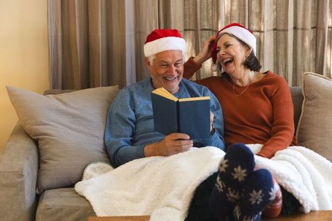 Senior Couple Enjoying Cozy Winter by Reading Together
