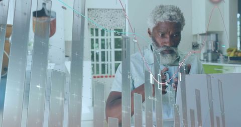 Senior Man Analyzing Financial Data With Digital Interface