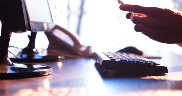 Office desk with computer, telephone, holding smartphone - Download Free Stock Images Pikwizard.com