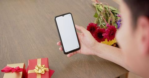 Man Holding Smartphone for Video Call with Holiday Gifts - Download Free Stock Images Pikwizard.com