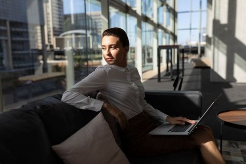 Professional Woman with Laptop in Modern Office Lounge - Download Free Stock Images Pikwizard.com