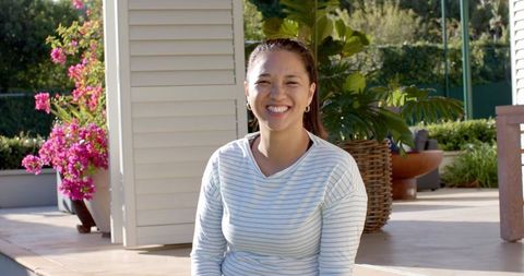 Asian Woman Smiling Joyfully Outdoors on a Bright Sunny Day