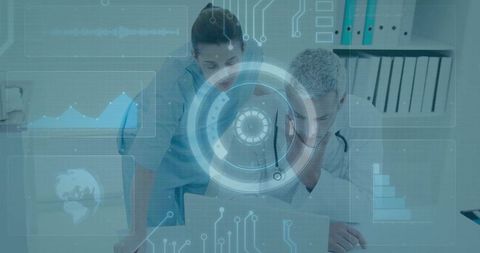 Clinician leaning on desk while nurse reviews laptop with futuristic medical hud dashboard