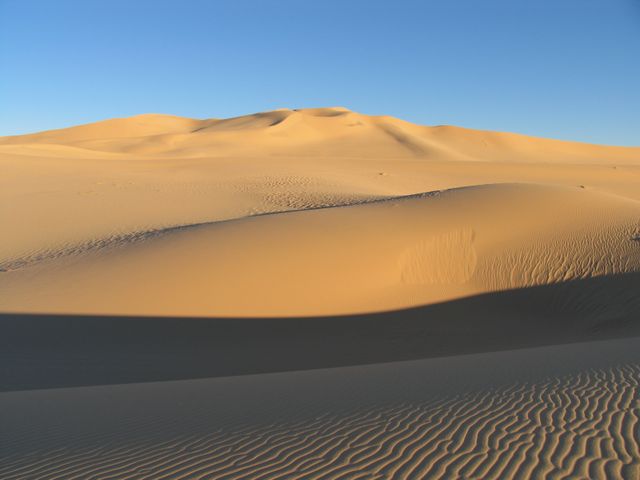 Golden Sand Dunes Desert Landscape Under Clear Blue Sky - Download Free Stock Photos Pikwizard.com