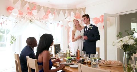 Bride and Groom Toasting with Friends at Intimate Home Wedding Celebration