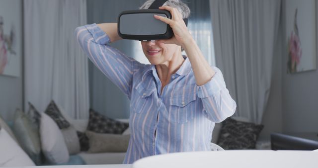 Senior Woman Using Virtual Reality Headset in Living Room - Download Free Stock Images Pikwizard.com