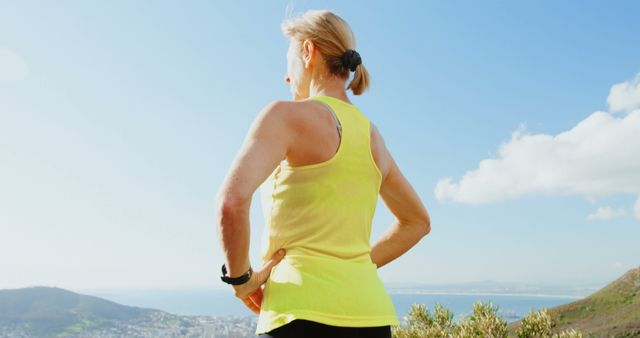 Senior Woman Enjoying Mountain View in Bright Yellow Tank Top - Download Free Stock Images Pikwizard.com