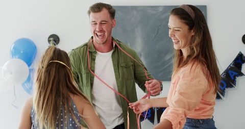Happy Family Dancing at Colorful Birthday Celebration