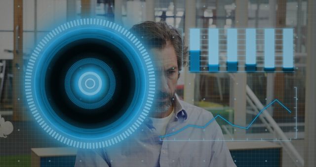 Image of arc reactor and graphs over diverse man working on laptop in office - Download Free Stock Photos Pikwizard.com