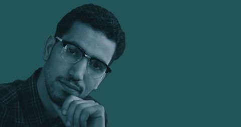 Pensive Man with Glasses on Teal Background - Download Free Stock Images Pikwizard.com