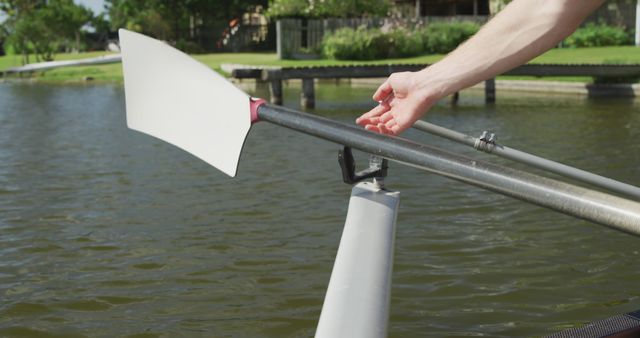 Person Adjusting Rowing Oar by Lake - Download Free Stock Images Pikwizard.com