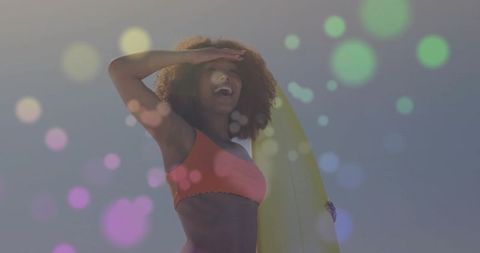 Joyful Afro-Centric Woman Ready to Surf in Summer Suns