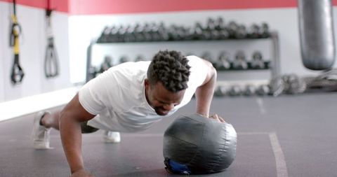 Fit Man Performing Medicine Ball Push-Ups at Gym - Download Free Stock Images Pikwizard.com