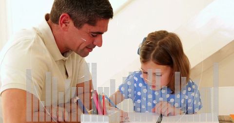 Man tutoring young girl at home helping with drawing and homework, warm family learning