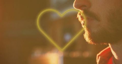 Caucasian Man Drinking Beer with Neon Heart Symbol Overlay