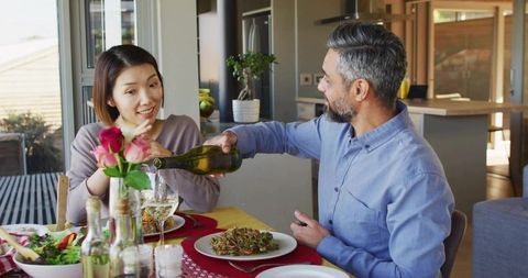 Couple Sharing Elegant Dinner with Wine at Home