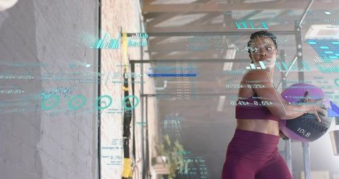 Woman Holding Medicine Ball with Fitness Analytics HUD Overlays in Sunlit Industrial Gym
