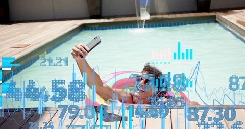 Young man taking pool selfie on colorful float with digital data overlay and analytics