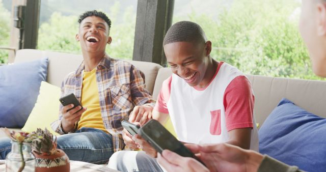 Teenage Friends Laughing Together While Using Smartphones Outdoors - Download Free Stock Images Pikwizard.com