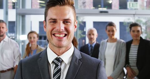 Confident Smiling Businessman Leading Office Team