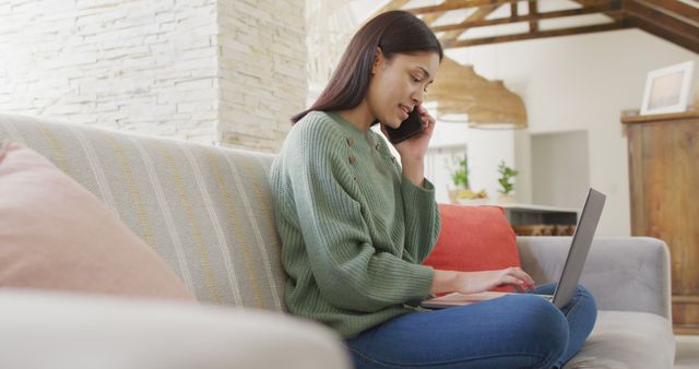 Young Woman Working from Home on Laptop While Talking on Phone - Download Free Stock Images Pikwizard.com