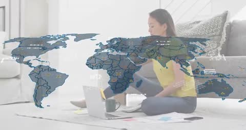 Remote analyst working on laptop with translucent global data map overlay