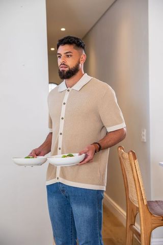 Man holding salad bowls in modern minimalist home