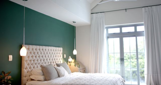 Bright Modern Bedroom with Green Accent Wall and Large Windows - Download Free Stock Images Pikwizard.com