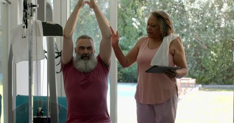 Senior couple stretching for fitness at home