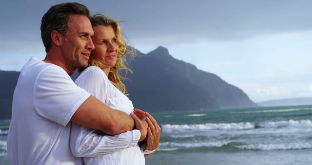 Happy Couple Embracing on a Scenic Beach - Download Free Stock Images Pikwizard.com