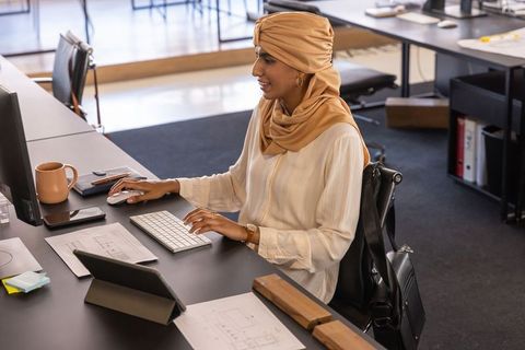 Architect reviewing floor plans in modern open-plan office